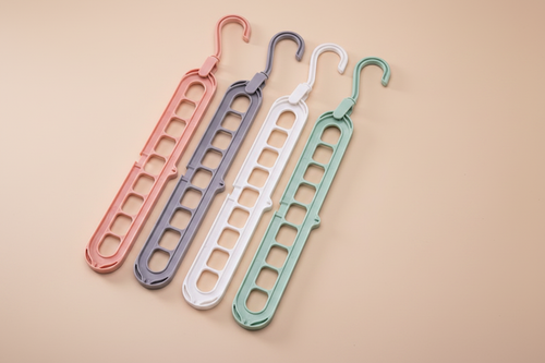 Four hangers on premium beige background